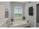 Relaxing bathroom with soaking tub and large window at 4037 Bal Harbor Blvd, Punta Gorda, FL 33950