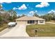 One-story home with a two-car garage and a boat parked in the driveway at 6104 Plamendon Ave, North Port, FL 34291