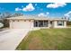 House exterior with attached garage and landscaped yard at 6104 Plamendon Ave, North Port, FL 34291