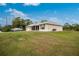 House exterior view showcasing side yard and boat at 6104 Plamendon Ave, North Port, FL 34291