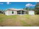 Exterior view of house with screened porch and detached shed at 6104 Plamendon Ave, North Port, FL 34291