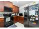 Modern kitchen with dark wood cabinets and stainless steel appliances at 6104 Plamendon Ave, North Port, FL 34291