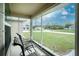 Relaxing screened porch with outdoor seating, overlooking a quiet street at 6104 Plamendon Ave, North Port, FL 34291