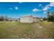 Detached storage shed with wooden ramp and grassy surroundings at 6104 Plamendon Ave, North Port, FL 34291