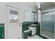 Bathroom with shower, green tile, and exterior access at 6365 Scorpio Ave, North Port, FL 34287