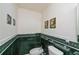 Small bathroom with green tiled walls, bidet, and toilet at 6365 Scorpio Ave, North Port, FL 34287