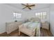Bedroom with wicker dresser, ceiling fan, and bed at 6365 Scorpio Ave, North Port, FL 34287