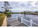 Private dock with a wooden deck and white fence at 6365 Scorpio Ave, North Port, FL 34287