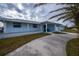 Light blue home with a covered porch and driveway at 6365 Scorpio Ave, North Port, FL 34287