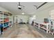 Large garage with storage shelving, workbench and exercise equipment at 6365 Scorpio Ave, North Port, FL 34287