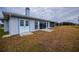 Rear view of the house showcasing a patio and yard at 6365 Scorpio Ave, North Port, FL 34287