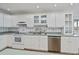 White kitchen with stainless steel appliances and green countertops at 6365 Scorpio Ave, North Port, FL 34287