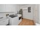 Laundry room with washer, dryer, and storage cabinets at 6365 Scorpio Ave, North Port, FL 34287