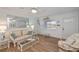 Bright living room with wicker furniture and wood floors at 6365 Scorpio Ave, North Port, FL 34287