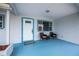 Covered porch with two wicker chairs and blue floor at 6365 Scorpio Ave, North Port, FL 34287