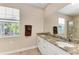 Double vanity bathroom with granite countertop and large mirror at 7342 N Ficus Tree, Punta Gorda, FL 33955