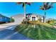 House with two palm trees, driveway and manicured lawn at 7342 N Ficus Tree, Punta Gorda, FL 33955