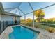 Screened pool and patio area with lush tropical landscaping at 7342 N Ficus Tree, Punta Gorda, FL 33955