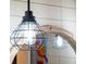 Modern caged pendant light fixture illuminates the bathroom at 7424 S Moss Rose, Punta Gorda, FL 33955