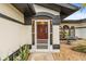 Inviting front entrance with red door and screened porch at 7424 S Moss Rose, Punta Gorda, FL 33955