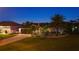 Home exterior at night with palm trees and landscape lighting at 7424 S Moss Rose, Punta Gorda, FL 33955