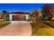 Attractive home exterior with a dark brown garage door and well-manicured lawn at 7424 S Moss Rose, Punta Gorda, FL 33955