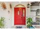 Red front door entry with decorative accents at 7424 S Moss Rose, Punta Gorda, FL 33955