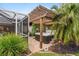 Hot tub with wooden pergola and lush tropical landscaping at 7424 S Moss Rose, Punta Gorda, FL 33955