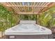 Relaxing hot tub under a pergola, surrounded by palm trees at 7424 S Moss Rose, Punta Gorda, FL 33955