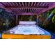 Relaxing hot tub under a wooden pergola with colorful lighting at 7424 S Moss Rose, Punta Gorda, FL 33955