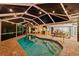 Enclosed pool area with string lights and comfortable seating at 7424 S Moss Rose, Punta Gorda, FL 33955