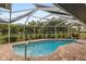 Screened-in pool area with a brick patio and string lights at 7424 S Moss Rose, Punta Gorda, FL 33955