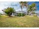 Landscaped backyard with lush lawn and tropical plants at 760 Bal Harbor Blvd, Punta Gorda, FL 33950