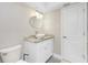 Updated bathroom with white vanity and a round mirror at 760 Bal Harbor Blvd, Punta Gorda, FL 33950