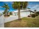 Single-Gathering home with white exterior, palm trees, and driveway at 760 Bal Harbor Blvd, Punta Gorda, FL 33950