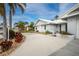 White single-story home with circular driveway, landscaping, and palm trees at 760 Bal Harbor Blvd, Punta Gorda, FL 33950