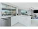 Modern kitchen with white cabinets and granite countertops, overlooking the pool at 760 Bal Harbor Blvd, Punta Gorda, FL 33950