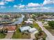 Aerial view of a canal-front home featuring a pool and spacious backyard at 840 Via Tunis, Punta Gorda, FL 33950