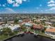 Aerial view of a home situated on a canal, featuring a private pool and lush landscaping at 840 Via Tunis, Punta Gorda, FL 33950