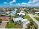 Aerial view of canal-front home with lush landscaping and two-car garage at 840 Via Tunis, Punta Gorda, FL 33950