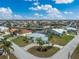 Aerial view of a waterfront home with pool and canal access in a sunny neighborhood at 840 Via Tunis, Punta Gorda, FL 33950