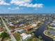 An aerial view showcasing a single Gathering home with a private pool and canal views at 840 Via Tunis, Punta Gorda, FL 33950