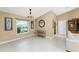 Bright dining room with large window, decorative mirror, and console table at 840 Via Tunis, Punta Gorda, FL 33950