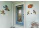 Front door entry with eclectic decor and blue door at 840 Via Tunis, Punta Gorda, FL 33950