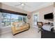 Sunroom with couch, water view, and workspace at 840 Via Tunis, Punta Gorda, FL 33950