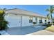 Front view of a single-story house with a white exterior and attached garage at 8541 Regency Ct, North Port, FL 34287