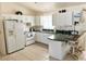 White kitchen with ample counter space and appliances at 8541 Regency Ct, North Port, FL 34287