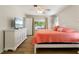 Bright bedroom with coral bedding and white dresser at 88 Sabal Dr, Punta Gorda, FL 33950