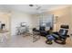 Living room features a black leather sofa and a ceiling fan at 88 Sabal Dr, Punta Gorda, FL 33950