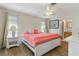 Main bedroom with coral bedding, white headboard, and wood floors at 88 Sabal Dr, Punta Gorda, FL 33950